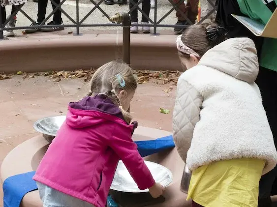 Pfarrerin bereitet eine Taufe mit zwei Kindern vor